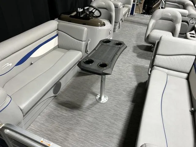 Slide: The Image of 2022 Bennington 22 SVSR pontoon boat interior with gray seating and central table. - 27