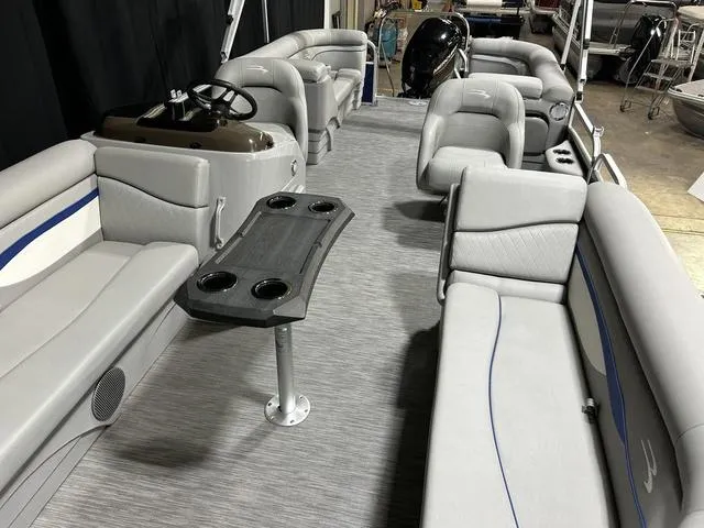 Slide: The Image of 2022 Bennington 22 SVSR pontoon boat interior with gray seating and a central table. - 28