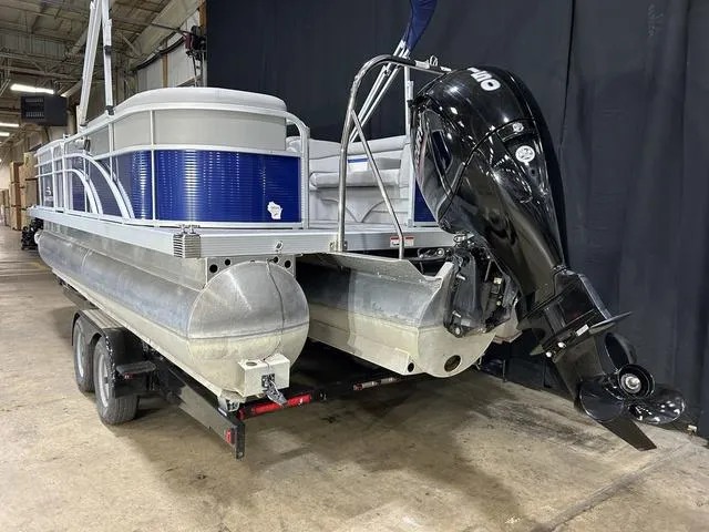 Slide: The Image of 2022 Bennington 22 SVSR pontoon boat on trailer, featuring a powerful outboard motor. - 5