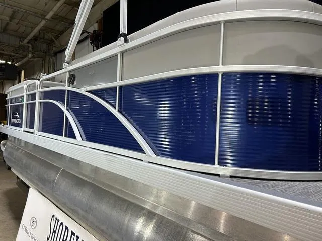 Slide: The Image of 2022 Bennington 22 SVSR pontoon boat with blue and silver exterior in showroom. - 9