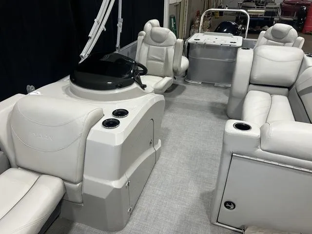 Slide: The Image of 2018 Sylvan 8522 Party Fish pontoon boat interior with plush seating and helm. - 22