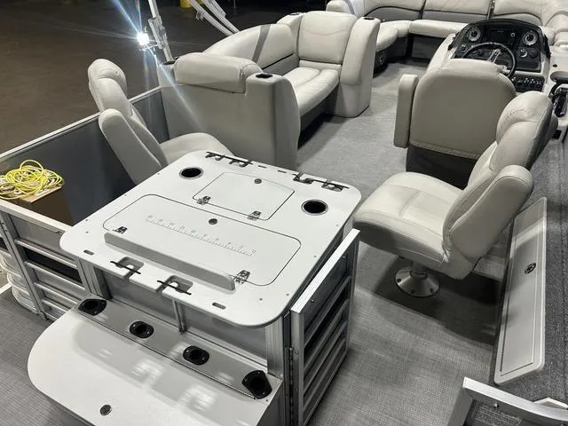 Slide: The Image of 2018 Sylvan 8522 Party Fish pontoon boat interior with plush seating and fishing station. - 9