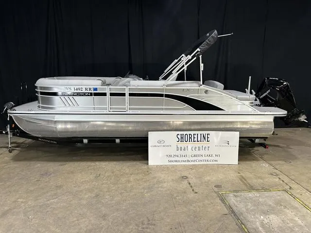 Slide: The Image of 2022 Bennington 24 LXSB pontoon boat displayed at Shoreline Boat Center. - 1