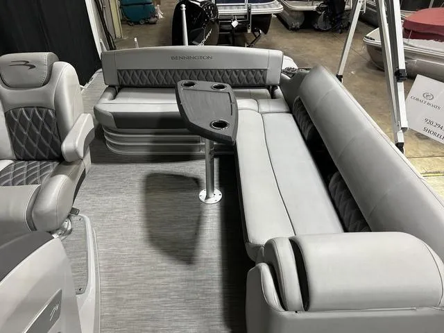 Slide: The Image of 2022 Bennington 24 LXSB boat interior with gray seating and table. - 14