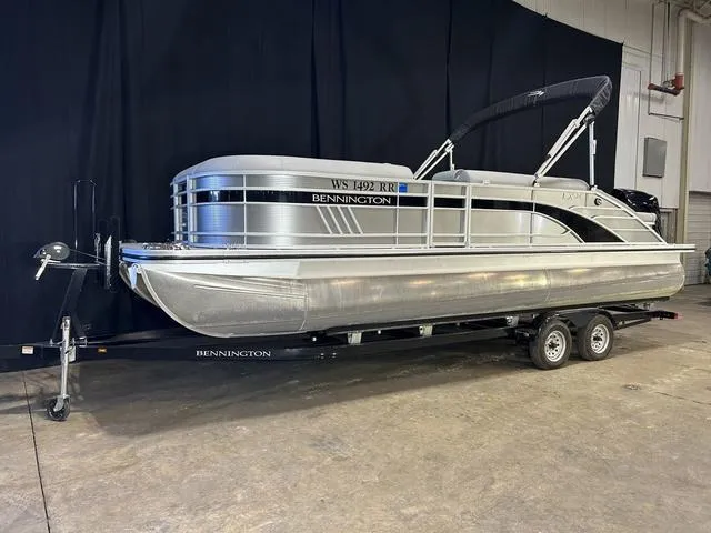 Slide: The Image of 2022 Bennington 24 LXSB pontoon boat on trailer in indoor setting. - 16