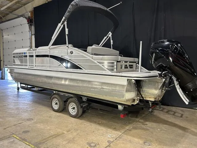 Slide: The Image of 2022 Bennington 24 LXSB pontoon boat on trailer in indoor setting. - 18