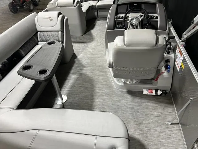 Slide: The Image of 2022 Bennington 24 LXSB boat interior with gray seating and steering console. - 21
