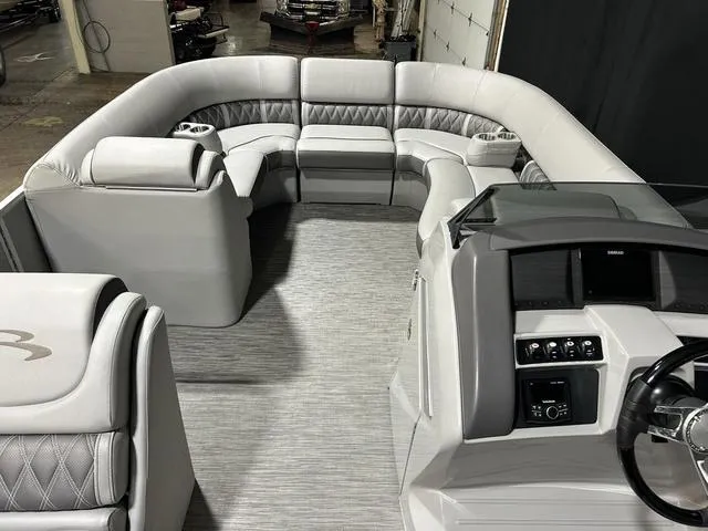 Slide: The Image of 2022 Bennington 24 LXSB pontoon boat interior with luxurious seating and modern dashboard. - 7