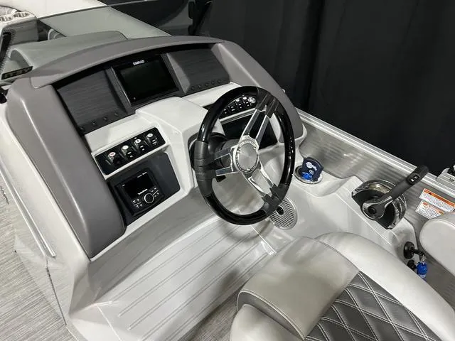 Slide: The Image of 2022 Bennington 24 LXSB boat dashboard with steering wheel and control panel. - 8