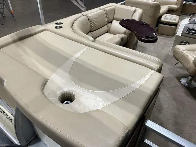 Slide: The Image of 2007 Bennington 2275 QXI pontoon boat interior with beige seating and cup holders. - 11