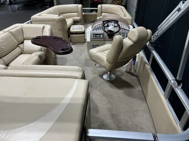 Slide: The Image of 2007 Bennington 2275 QXI pontoon boat interior with beige seating and steering console. - 12