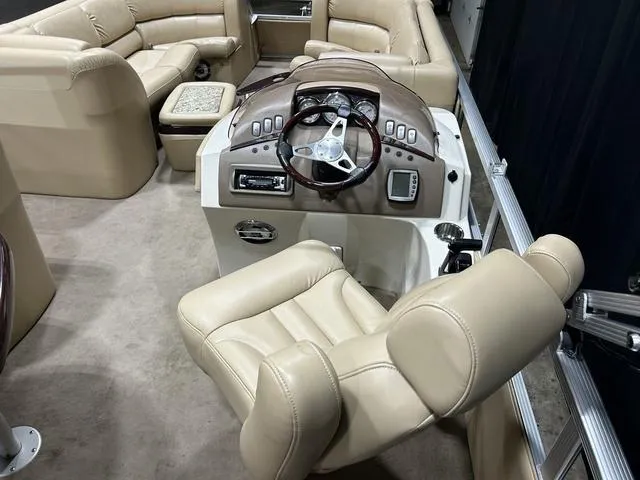 Slide: The Image of Luxurious interior of 2007 Bennington 2275 QXI boat with beige seating and steering console. - 13