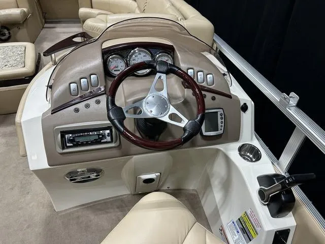 Slide: The Image of 2007 Bennington 2275 QXI boat dashboard with steering wheel, gauges, and controls. - 14