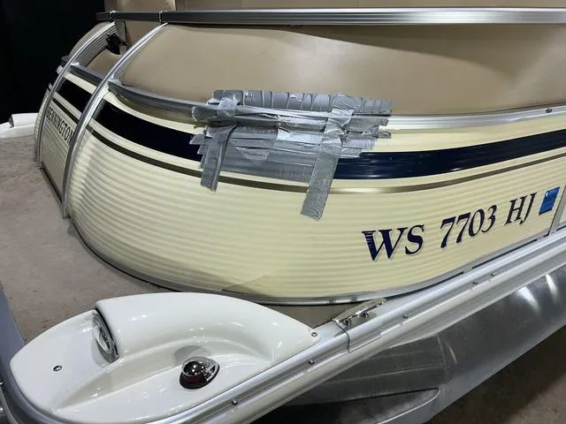 Slide: The Image of 2007 Bennington 2275 QXI boat with duct tape repair on the side. - 4