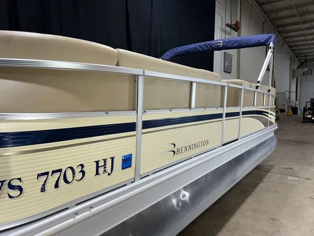 Slide: The Image of 2007 Bennington 2275 QXI pontoon boat in a warehouse setting. - 5