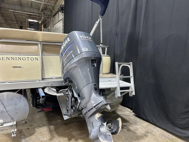 Slide: The Image of 2007 Bennington 2275 QXI pontoon boat with Yamaha 150 outboard motor in a warehouse. - 7