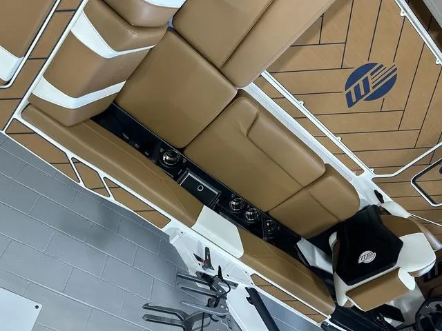 Slide: The Image of 2024 Malibu 23 LSV boat interior with tan seating and stylish design. - 12