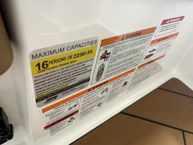 Slide: The Image of 2024 Malibu 23 LSV capacity label, maximum 16 persons or 2256 lbs, safety warnings visible. - 20