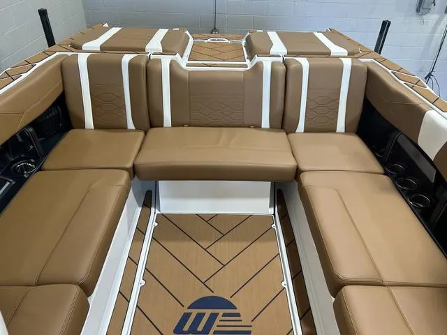 Slide: The Image of 2024 Malibu 23 LSV boat interior with tan leather seating and stylish design. - 24