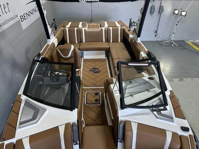 Slide: The Image of 2024 Malibu 23 LSV boat interior with brown and white seating, modern design. - 27