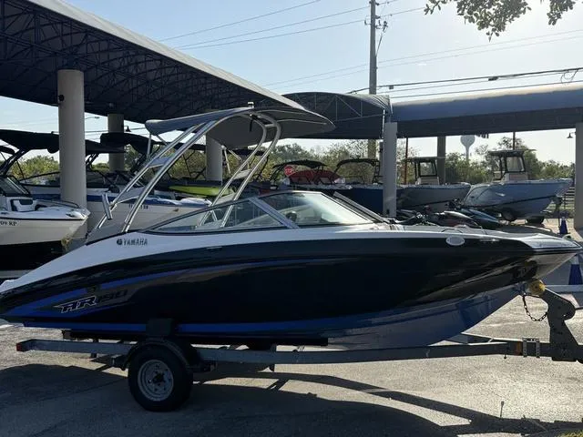 Slide: The Image of 2017 Yamaha Boats AR190 on trailer at a marina, side view. - 18