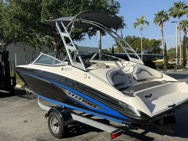 Slide: The Image of 2017 Yamaha AR190 boat on trailer, sleek design, parked outdoors with palm trees. - 21