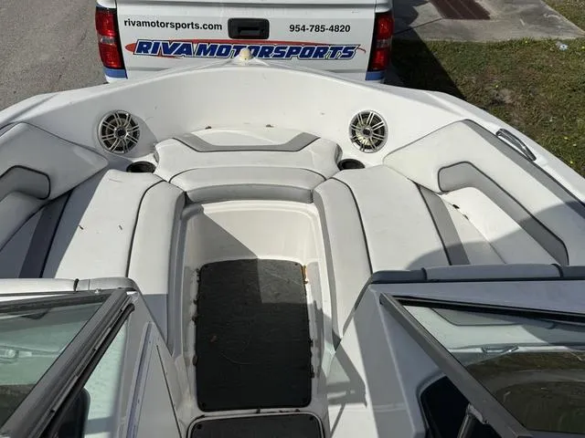 Slide: The Image of 2017 Yamaha AR190 boat interior with seating and speakers, parked near Riva Motorsports vehicle. - 7