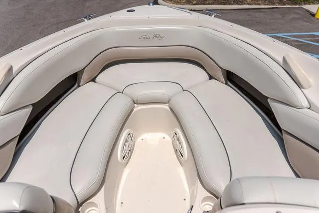 Slide: The Image of 2003 Sea Ray 240 SIGNATURE boat interior with white cushioned seating. - 10