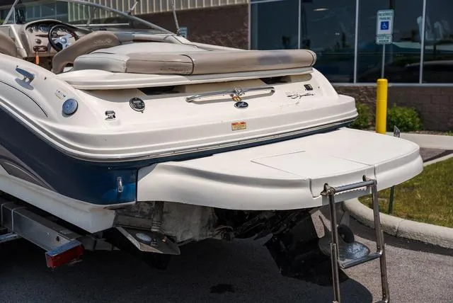Slide: The Image of 2003 Sea Ray 240 Signature BR boat interior with seating and canopy in a showroom. - 4