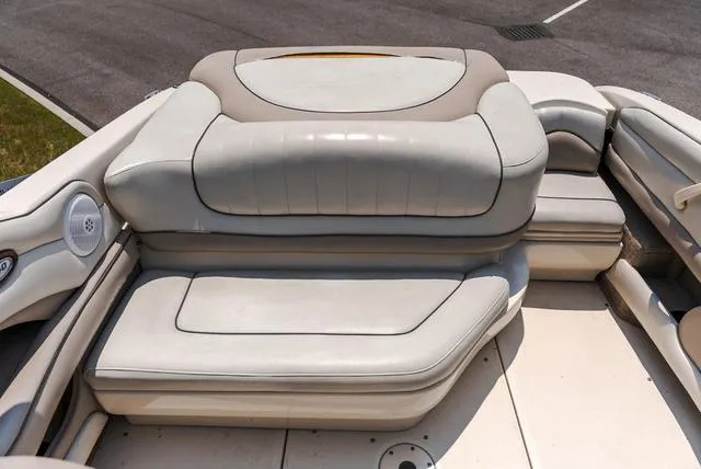 Slide: The Image of 2003 Sea Ray 240 Signature boat interior seating, featuring plush white upholstery. - 6