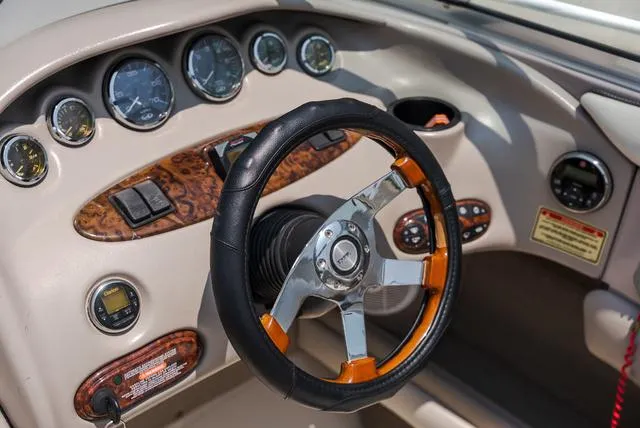 Slide: The Image of Steering wheel and dashboard of 2003 Sea Ray 240 Signature boat. - 9
