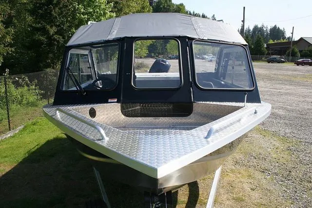 Slide: The Image of 2025 Thunder Jet 200 Luxor boat with aluminum deck, parked outdoors. - 13