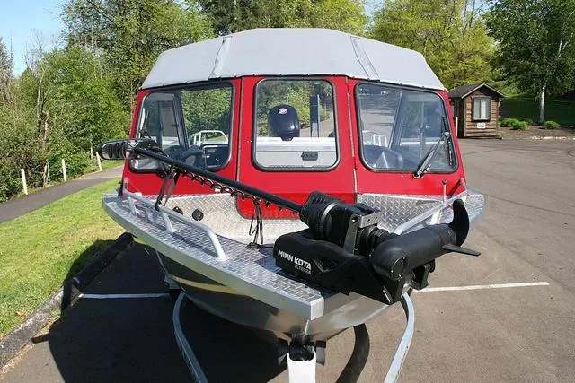 Slide: The Image of 2021 Thunder Jet 185 Luxor boat with Minn Kota motor, parked outdoors. - 12