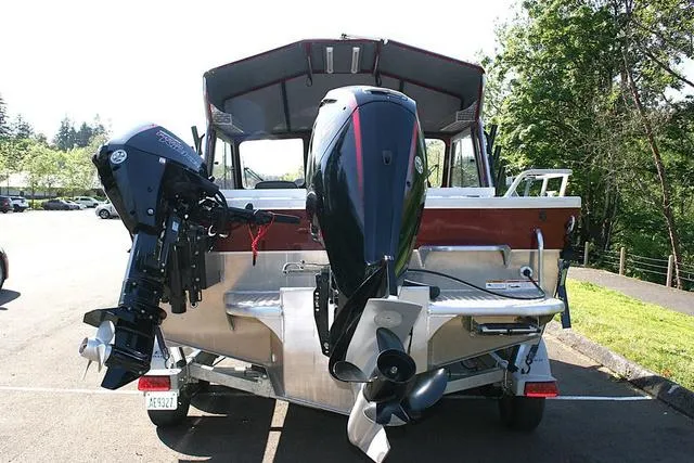 Slide: The Image of 2021 Thunder Jet 185 Luxor boat with dual outboard motors in a parking area. - 4