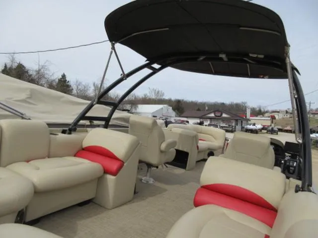 Slide: The Image of 2017 Landau 230C Atlantis Cruise Tritoon with beige and red seating, under a black canopy. - 12