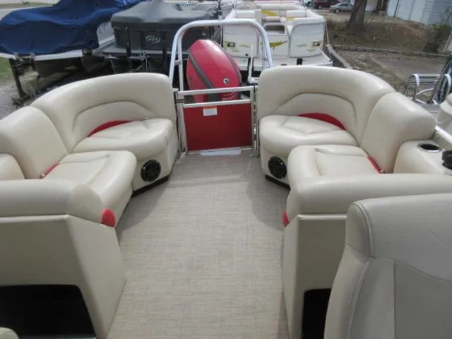 Slide: The Image of 2017 Landau 230C Atlantis Cruise Tritoon with beige seating and red accents. - 14