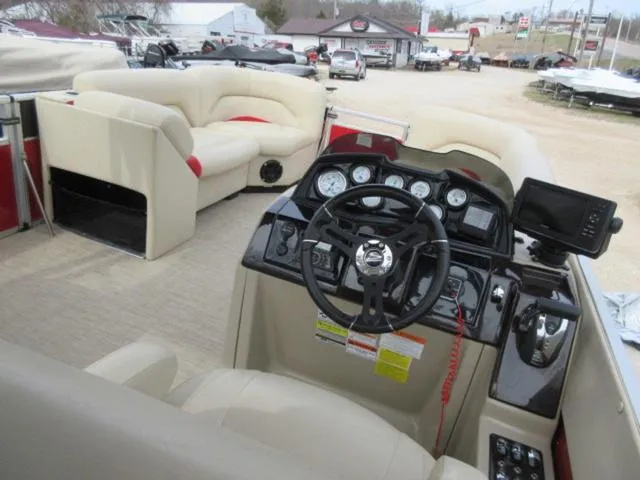Slide: The Image of 2017 Landau 230C Atlantis Cruise Tritoon interior with steering console and seating. - 17