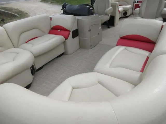Slide: The Image of 2017 Landau 230C Atlantis Cruise Tritoon interior with beige and red seating. - 20