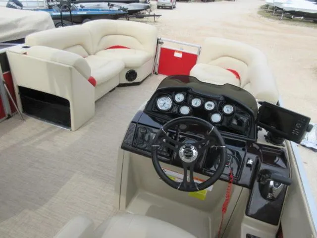 Slide: The Image of 2017 Landau 230C Atlantis Cruise Tritoon interior with steering console and seating. - 5