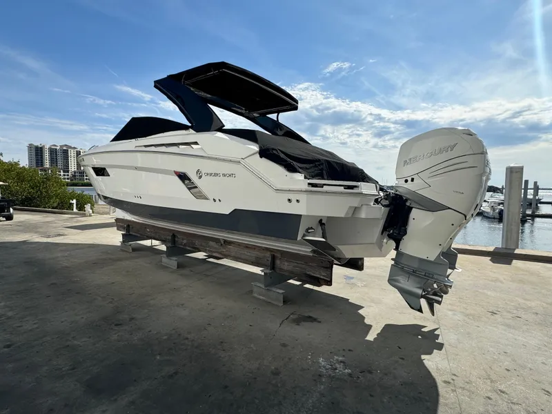 Slide: The Image of 2019 Cruisers Yachts 338 Outboard on dock, sunny marina background. - 5