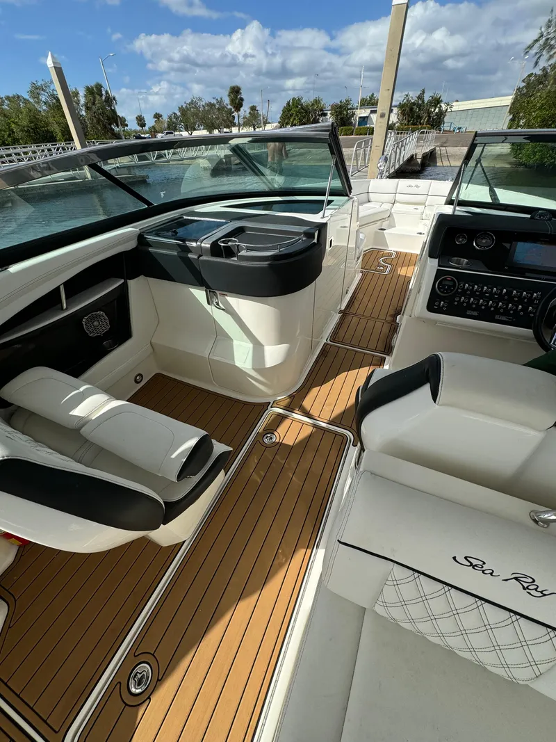 Slide: The Image of 2015 Sea Ray 350 SLX boat interior with luxurious seating and modern dashboard. - 12