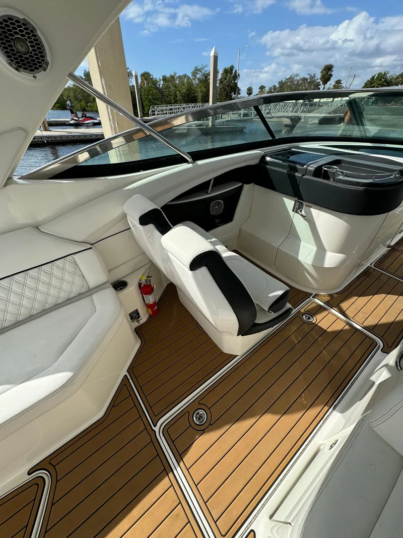 Slide: The Image of 2015 Sea Ray 350 SLX boat interior with luxurious seating and wood flooring. - 13