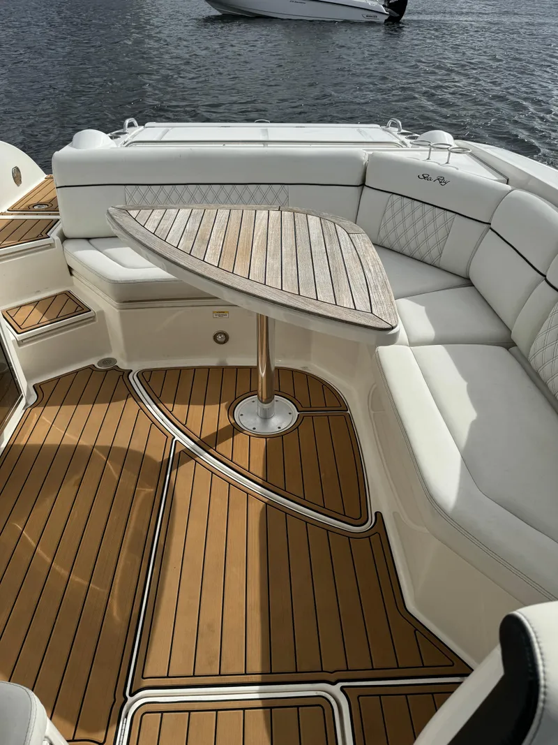 Slide: The Image of 2015 Sea Ray 350 SLX boat with elegant seating and wooden table on deck. - 14