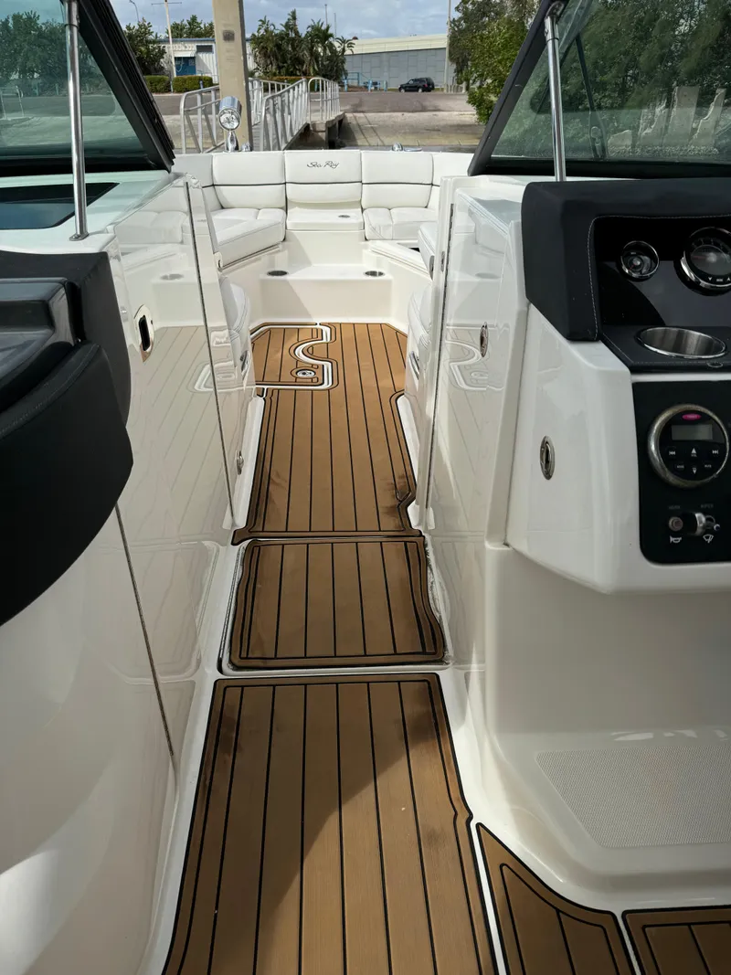 Slide: The Image of 2015 Sea Ray 350 SLX boat interior with teak flooring and modern dashboard. - 16