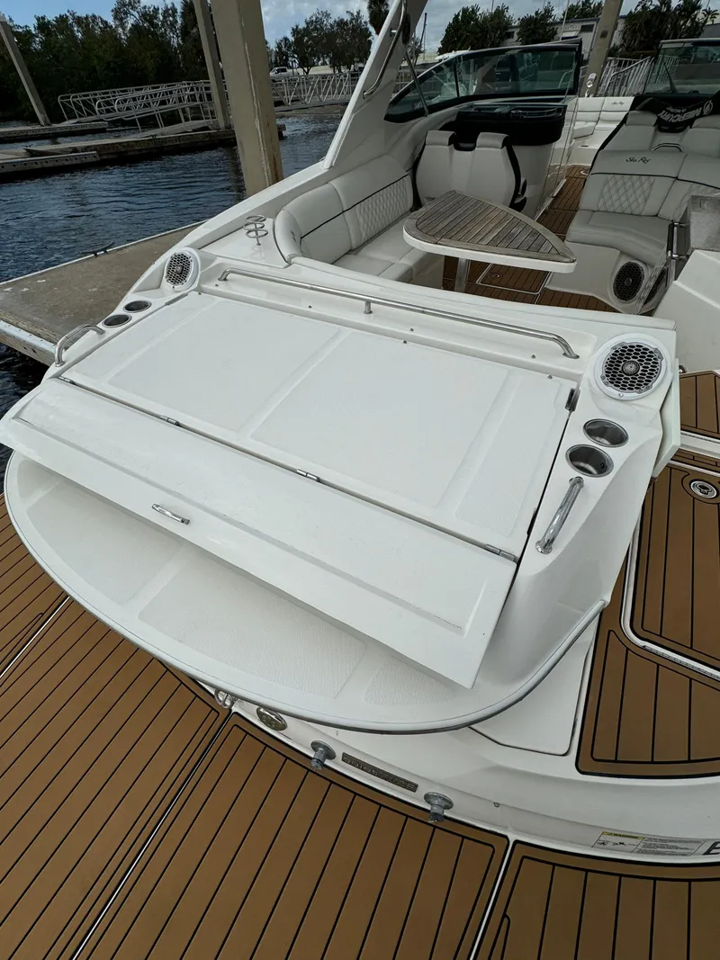 Slide: The Image of 2015 Sea Ray 350 SLX boat with spacious deck and seating area. - 18