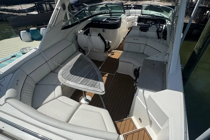 Slide: The Image of 2015 Sea Ray 350 SLX boat interior with spacious seating and elegant design. - 2