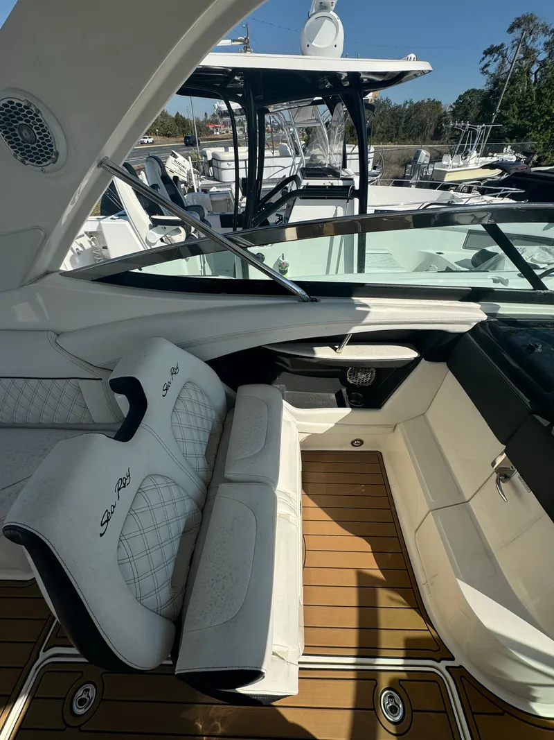 Slide: The Image of 2015 Sea Ray 350 SLX boat interior with white seating and teak flooring. - 21