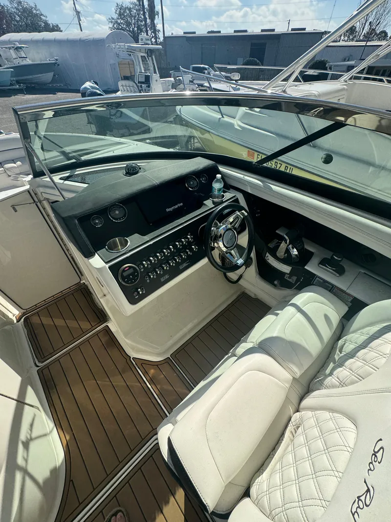 Slide: The Image of 2015 Sea Ray 350 SLX boat cockpit with luxurious seating and modern controls. - 23