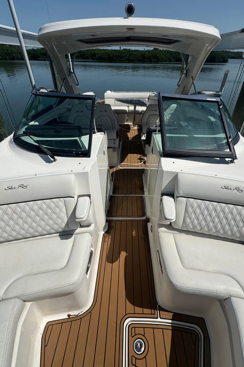 Slide: The Image of 2015 Sea Ray 350 SLX boat interior with white seating and wooden deck. - 24