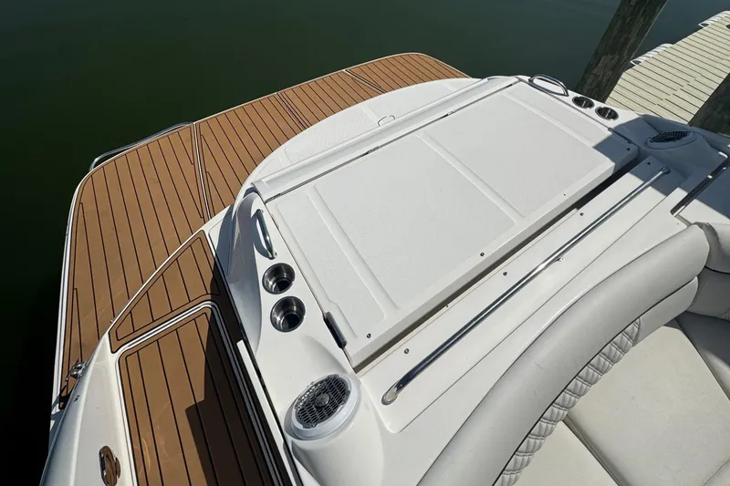 Slide: The Image of 2015 Sea Ray 350 SLX boat deck with teak flooring and white seating. - 25